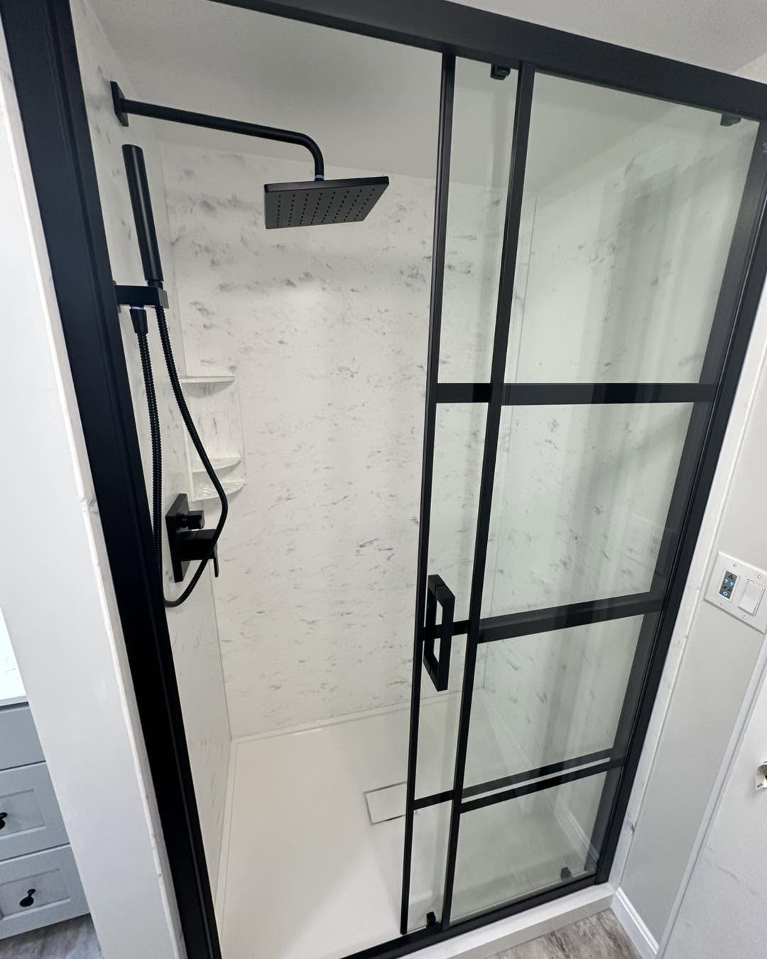 Premium bathroom renovation — black frame glass shower, marble tile, Deerfield NY