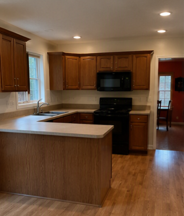 Kitchen before remodel &mdash; dated oak cabinets and dark appliances